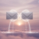 two silver envelopes floating in a silver coloured sky